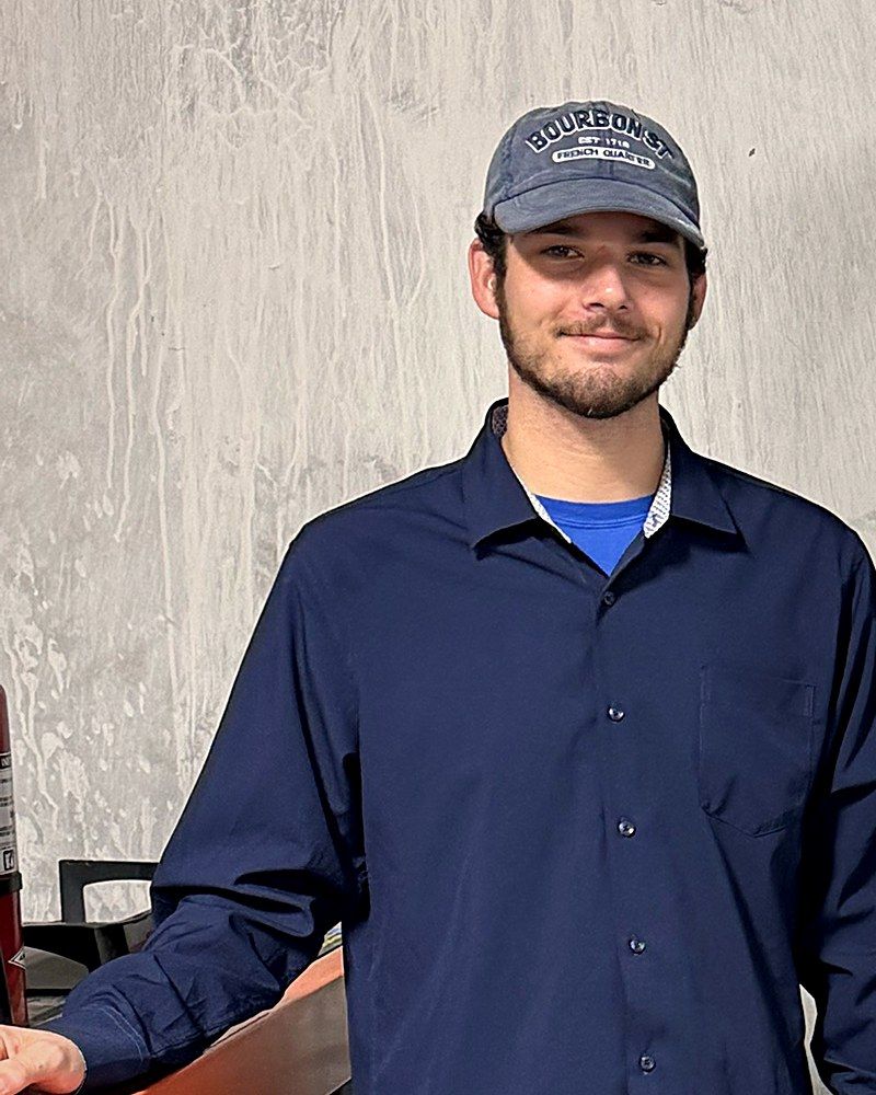 Portrait of Craig Anthes, owner of MCA Vending, in a navy button-up shirt and ball cap.